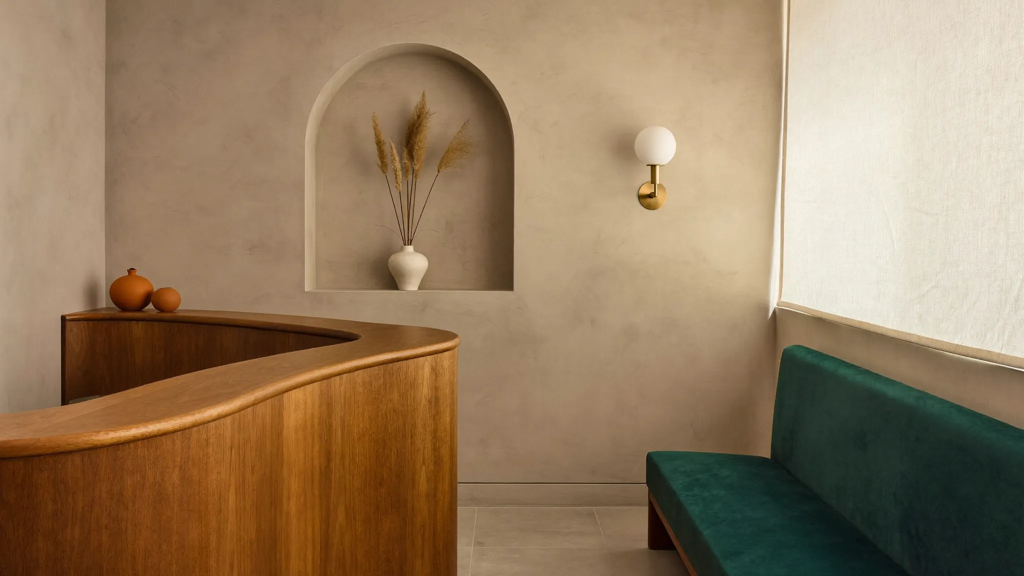 The Tandem reception — warm limewash walls, curved walnut desk, morning light